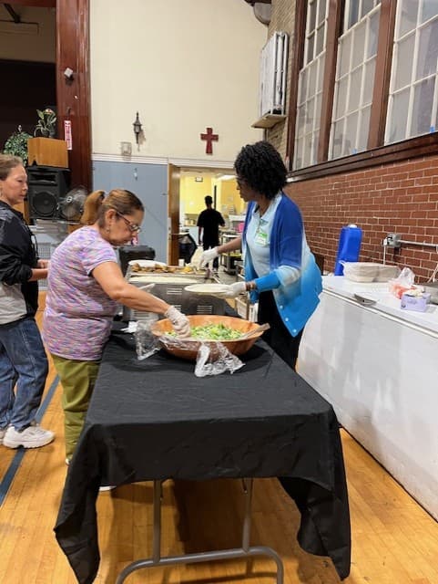 Serve team members serving salad at Dinner Church